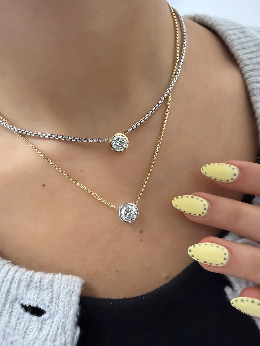 Bezel solitaire necklaces in yellow and white gold